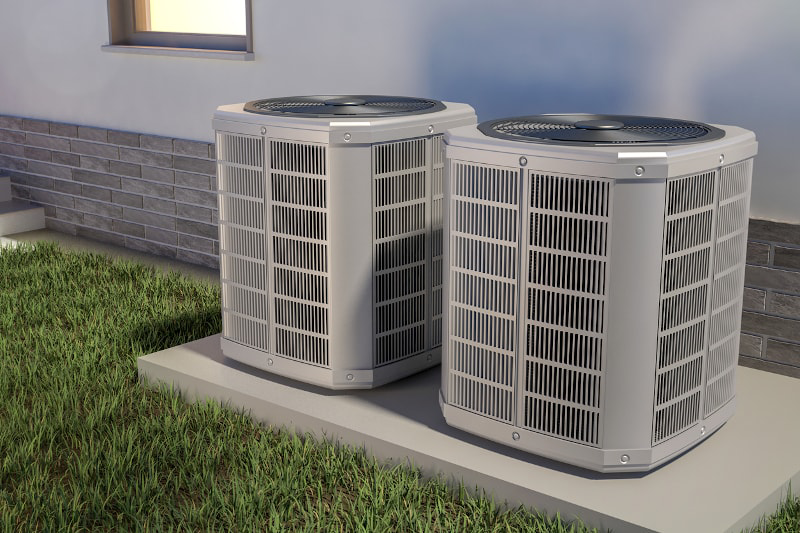 Two modern outdoor air conditioning units installed next to a residential building by Climate Control in San Antonio, TX