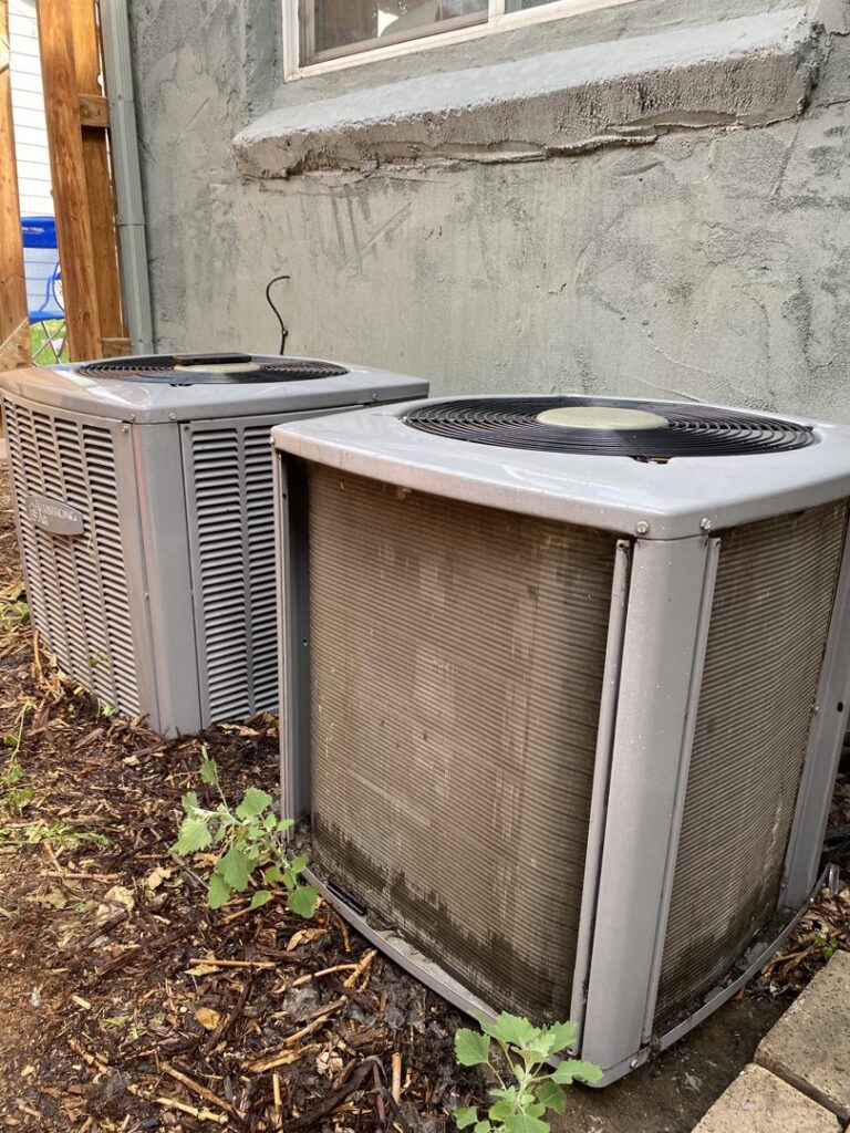 Two outdoor air conditioning units, one appearing older, ready for service or replacement by Fix It Now Heating and Cooling in Thornton, CO