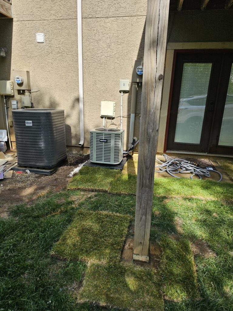 Two outdoor AC units, a Gibson and a Trane, installed by A-Team PHC at a residential property in Olathe, KS.