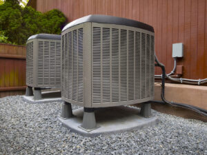 Two outdoor air conditioning units, representing HVAC equipment services by Garden City Plumbing & Heating in Missoula, MT