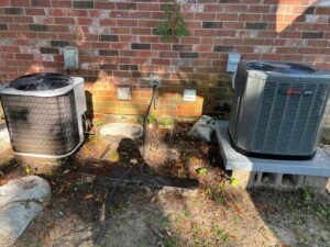 Two outdoor air conditioning units installed next to a brick wall by 5 Star Charleston Heating and Air in Charleston, SC.