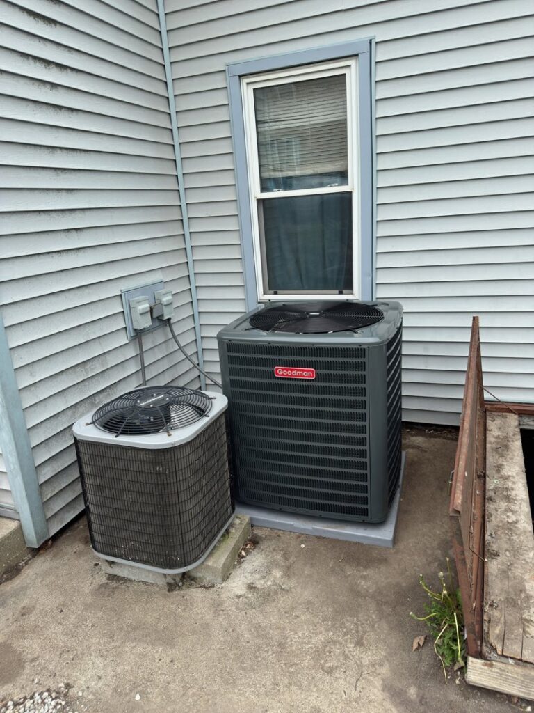 Two outdoor AC units, including a Goodman unit, installed by Breezy Brothers Heating and Cooling in Lafayette, IN.