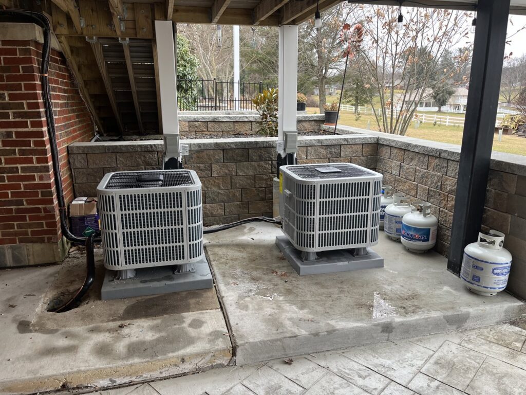 Two outdoor AC units installed on concrete pads by Complete Mechanical Solutions in Novi, MI