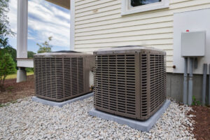Two residential outdoor air conditioning units installed next to a house by Trenary Service Company in Martinsburg, WV.