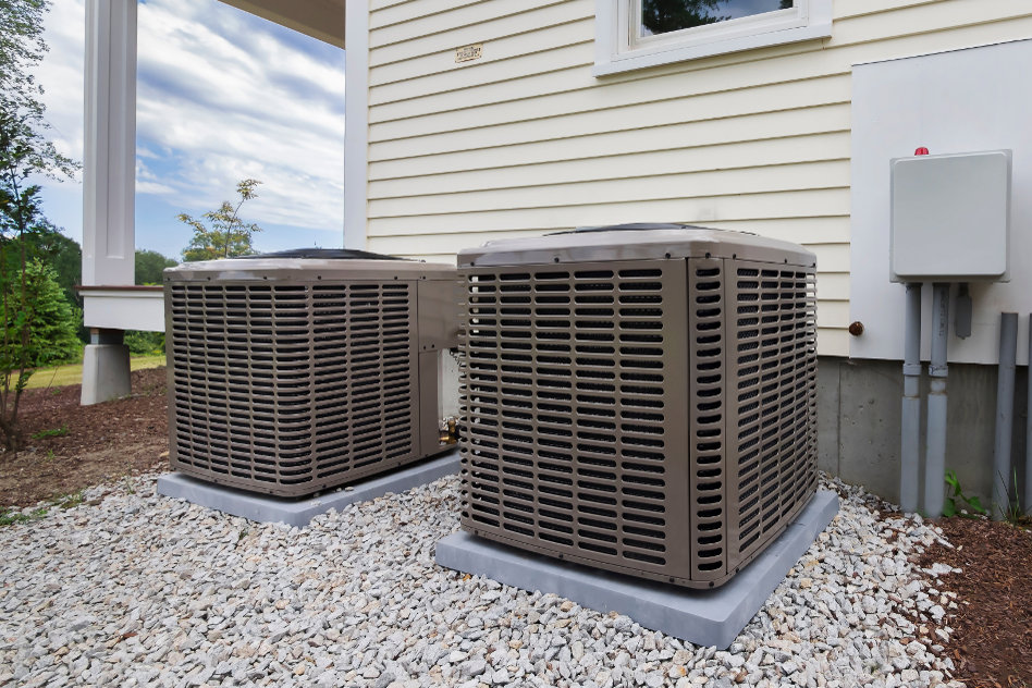 Two residential outdoor air conditioning units installed next to a house by Trenary Service Company in Martinsburg, WV.