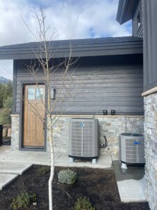 Two outdoor air conditioning units installed next to a modern home by Boise Valley Heating & Air in Meridian, ID
