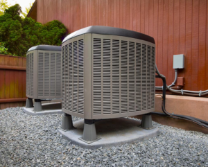 Two outdoor HVAC condenser units installed next to a building by Climate Shield Heating & Cooling LLC in Yonkers, NY