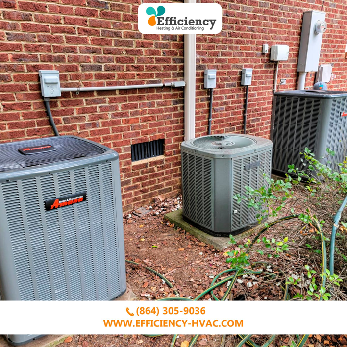 Two outdoor HVAC condenser units installed next to a brick residential home by Efficiency HVAC in Milwaukie, OR.