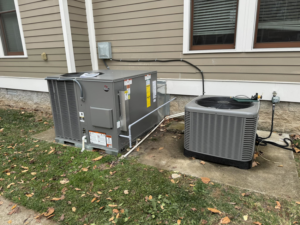 Two outdoor HVAC condenser units installed next to a residential home by Nashville Heating & Air in Gallatin, TN