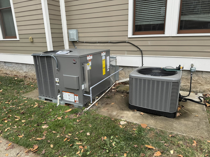 Two outdoor HVAC condenser units installed next to a residential home by Nashville Heating & Air in Gallatin, TN