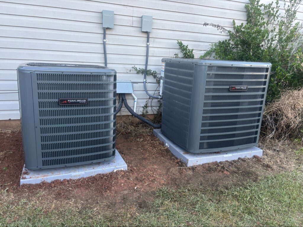 Two newly installed outdoor HVAC condenser units next to a residential building by Summit Service Heating and Air in Hilton Head Island, SC.