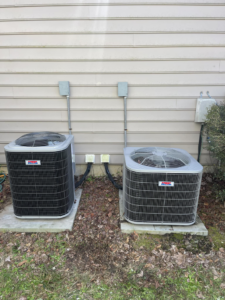 Two outdoor HVAC condenser units installed next to a residential building by Wicked Cool HVAC in Charleston, SC.