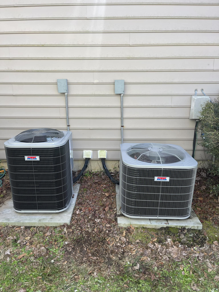 Two outdoor HVAC condenser units installed next to a residential building by Wicked Cool HVAC in Charleston, SC.