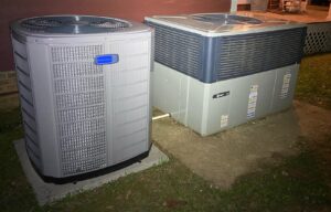 Two outdoor HVAC units, an American Standard and a Trane, installed side-by-side by A/C Company Since 1988 in Murfreesboro, TN.