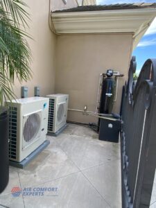Two outdoor HVAC units installed next to a building by Air Comfort Experts in Pasadena, CA