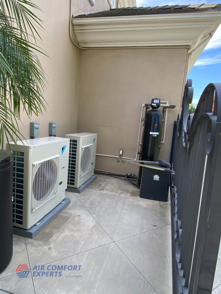Two outdoor HVAC units installed next to a building by Air Comfort Experts in Pasadena, CA