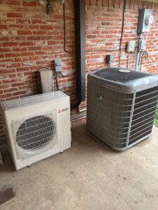 Two outdoor HVAC units, including a Mitsubishi mini-split, installed by Community Mechanical in Plano, TX.
