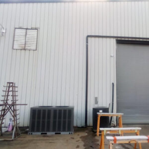 Two outdoor HVAC condenser units positioned next to a commercial building, indicating installation or service by Eleven Heating and Cooling in Birmingham, AL.