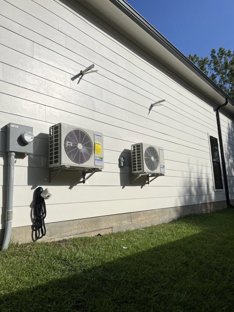 Two Pioneer mini-split outdoor units installed on the side of a house by Comfort Zone AC and Heating Services LLC in Sunrise Beach, MO
