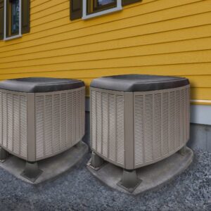 Two residential air conditioning units installed next to a yellow house by All The Way Heating & Cooling in Middleburgh, NY