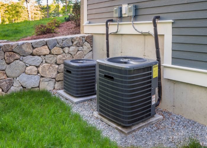Two residential AC condenser units installed outside a home by Rhode Island HVAC Services in Providence, RI.