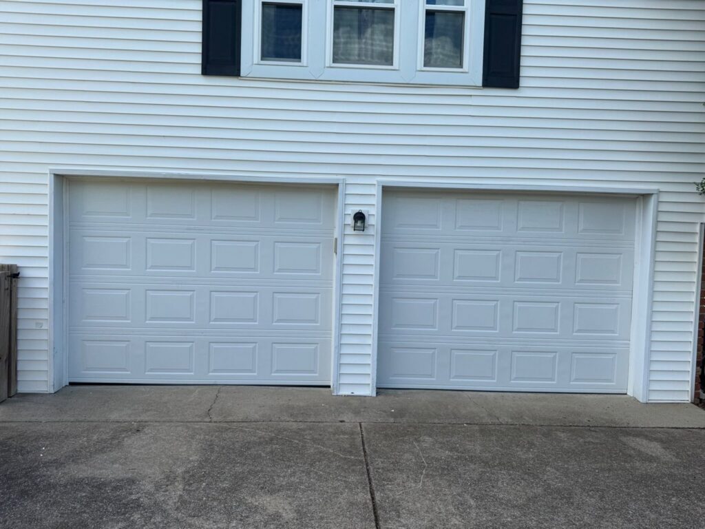 Two white panel garage doors on a residential home, showcasing work by Swift Garage Door in Nashville, TN.
