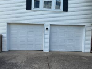 Two white panel garage doors on a residential home, showcasing work by Swift Garage Door in Nashville, TN.