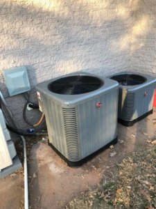Two Rheem outdoor AC condenser units installed by HVAC Experts, LLC in Edmond, OK.