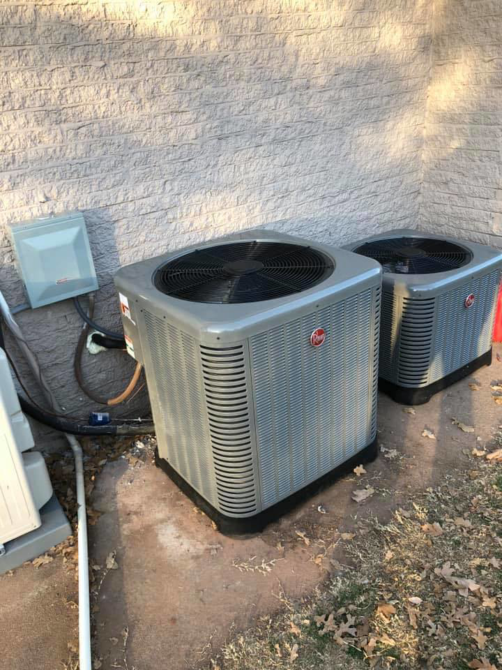 Two Rheem outdoor AC condenser units installed by HVAC Experts, LLC in Edmond, OK.