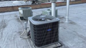Two outdoor AC condenser units on a rooftop installed by Etek Refrigeration Heating and Cooling, Inc. in Chicago, IL.