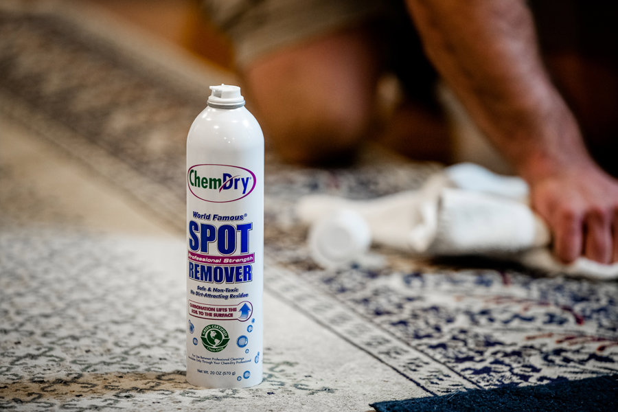 Two H-Town Chem-Dry technicians with carpet cleaning equipment in a client's living room in Spring, TX