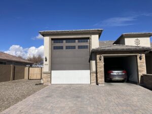 A newly installed two-tone garage door with top windows by Anew Garage by Jon's Garages in Surprise, AZ.