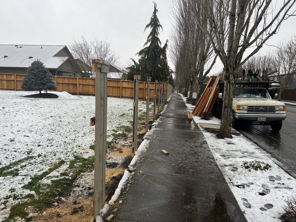 A modern two-tone white and grey privacy fence, expertly installed by Fence Repair Master in Vancouver, WA.