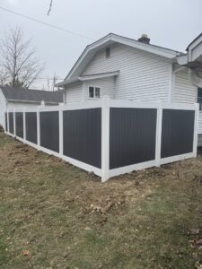 A modern two-tone vinyl privacy fence installed by Hoplite Services in Indianapolis, IN.