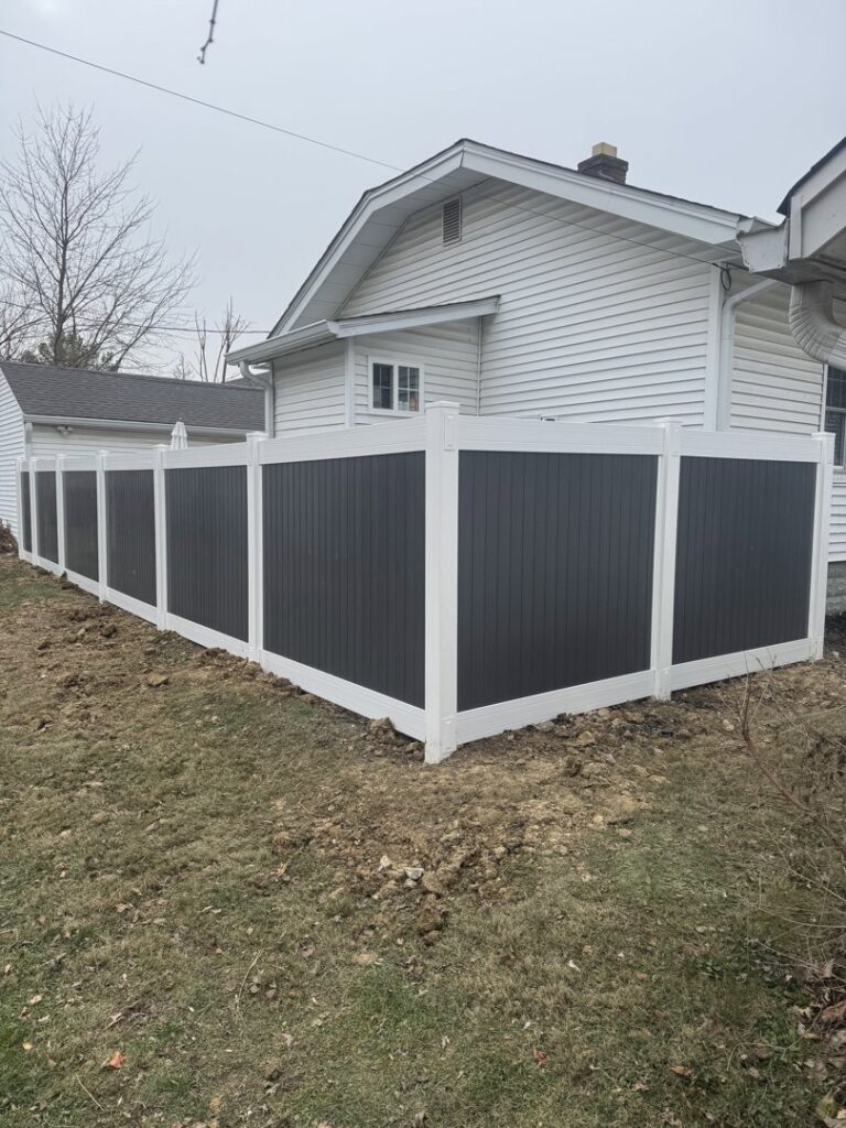 A modern two-tone vinyl privacy fence installed by Hoplite Services in Indianapolis, IN.