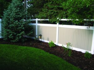 A stylish two-tone vinyl privacy fence, offering durability and aesthetic appeal, installed by Fence Guru LLC in Denver, CO.