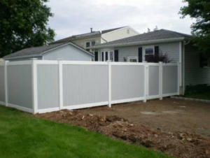 A modern two-tone grey and white vinyl privacy fence installed for a residential home by Keith's Fence Co LLC in Edison, NJ.