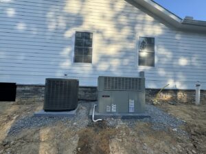 Two Trane outdoor HVAC condenser units installed next to a residential building by Federal Heating & Cooling in Dresden, OH.