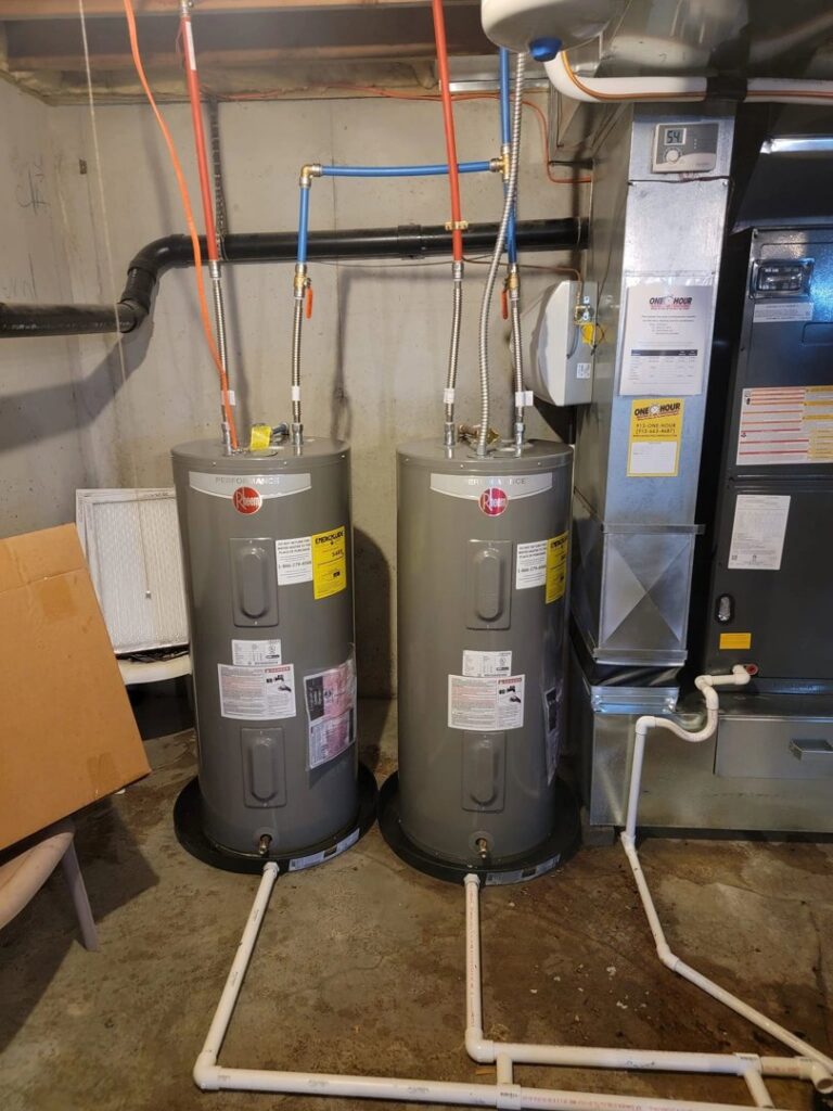 Two new water heaters and a furnace installed by Working Wolves Heating & Cooling LLC in a Lawrence, KS basement.