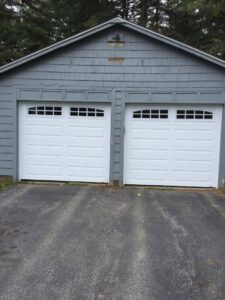 Two white garage doors with top windows installed by Snowbird Garage Doors Company in Worcester, MA.