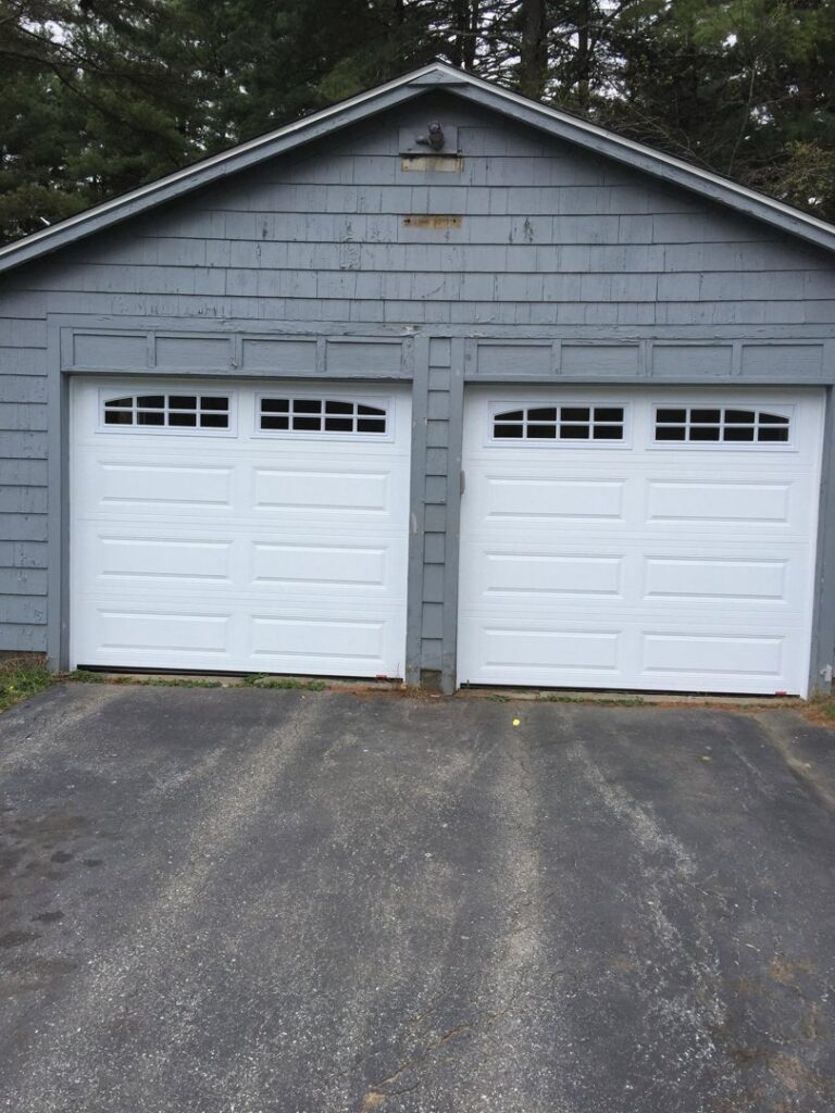 Two white garage doors with top windows installed by Snowbird Garage Doors Company in Worcester, MA.