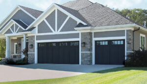 A large home with two white garage doors featuring top windows, installed by Overhead Door Company of Evansville in Evansville, IN.