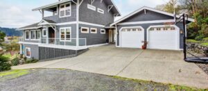 A modern home featuring two white panel garage doors installed by Overhead Door Company of Evansville in Evansville, IN.