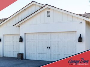 Two classic white residential garage doors installed on a home by Garage Doors Of Indianapolis in Indianapolis, IN