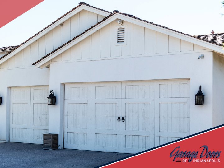 Two classic white residential garage doors installed on a home by Garage Doors Of Indianapolis in Indianapolis, IN