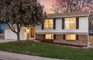 Two elegant wood-look garage doors installed on a residential home by Lion Heart Garage Doors in Thornton, CO.