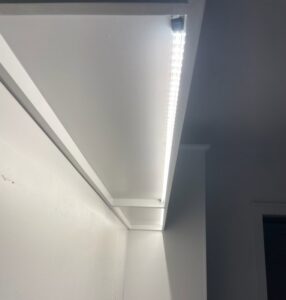 Close-up of under-cabinet LED strip lighting installation, a service provided by LOJ Electric, LLC in Houston, TX.