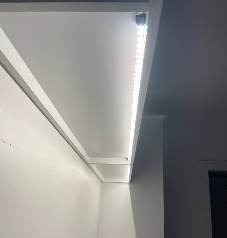 Close-up of under-cabinet LED strip lighting installation, a service provided by LOJ Electric, LLC in Houston, TX.