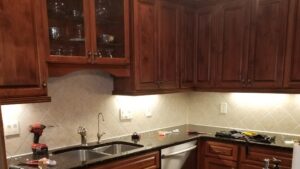 Under-cabinet lighting installed in a kitchen with tools on the counter by Top Tier Electrical Services LLC in Knoxville, TN