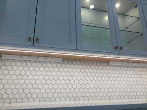 Under-cabinet lighting and power strip installation by Cannizzo Electric, Inc. in Rochester, NY.